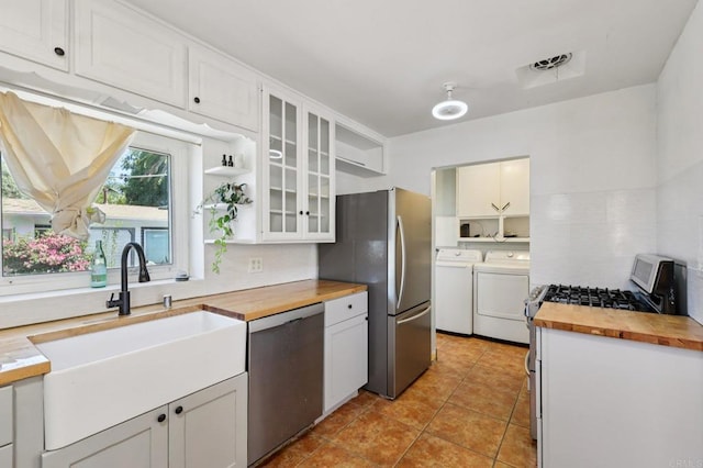 1220 Palomar Ter, Escondido, CA 92027 - kitchen with butcher block countertops, stainless steel appliances, washer and dryer, and open shelves