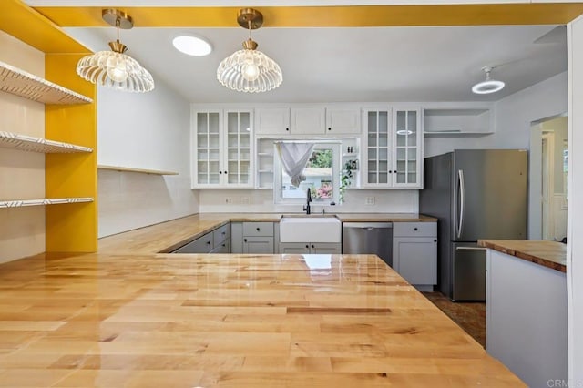 1220 Palomar Ter, Escondido, CA 92027 - kitchen with wooden counters, stainless steel appliances, open shelves, and hanging light fixtures