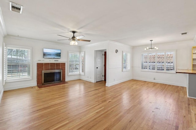 1220 Palomar Ter, Escondido, CA 92027 - unfurnished living room with a ceiling fan, light wood-type flooring, a chandelier, a brick fireplace, and crown molding