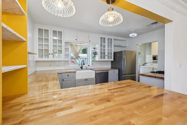 1220 Palomar Ter, Escondido, CA 92027 - kitchen featuring wood counters, appliances with stainless steel finishes, a chandelier, and decorative backsplash