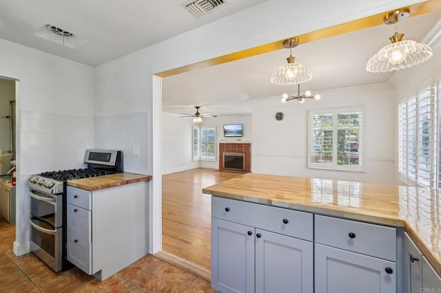 1220 Palomar Ter, Escondido, CA 92027 - kitchen with double oven range, butcher block counters, healthy amount of natural light, and a ceiling fan