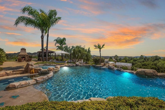 14786 Cool Valley Ranch Rd, Valley Center, CA 92082 - view of pool featuring an outdoor stone fireplace, a patio, and a pool with connected hot tub