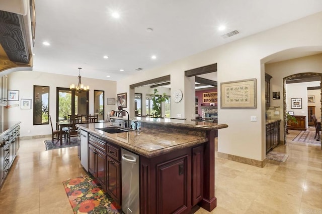 14786 Cool Valley Ranch Rd, Valley Center, CA 92082 - kitchen with a chandelier, arched walkways, recessed lighting, dark stone countertops, and an island with sink
