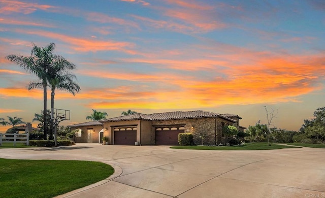 14786 Cool Valley Ranch Rd, Valley Center, CA 92082 - mediterranean / spanish home featuring an attached garage, curved driveway, a tile roof, a front yard, and stucco siding