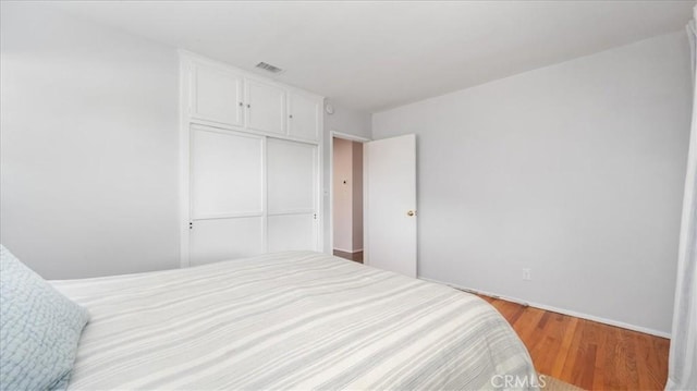 1193 Winston Ct, Upland, CA 91786 - bedroom with a closet and wood finished floors