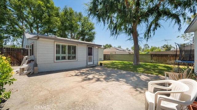 1193 Winston Ct, Upland, CA 91786 - back of property featuring a trampoline, a patio, and a fenced backyard