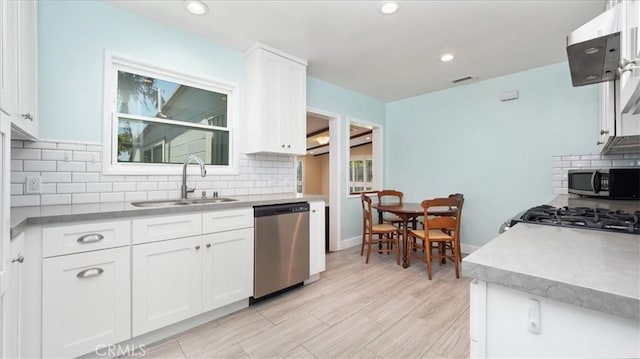 1193 Winston Ct, Upland, CA 91786 - kitchen with stainless steel appliances, white cabinets, decorative backsplash, and recessed lighting