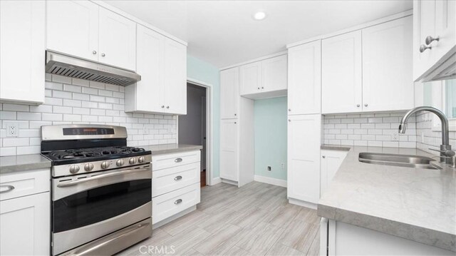 1193 Winston Ct, Upland, CA 91786 - kitchen featuring gas range, exhaust hood, white cabinetry, tasteful backsplash, and recessed lighting