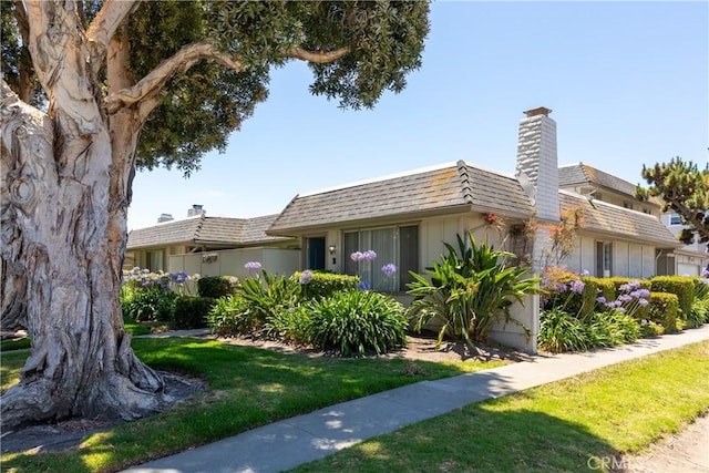 1841 Fisher Dr Unit B, Oxnard, CA 93035 - view of front of home featuring a chimney, a front lawn, and mansard roof