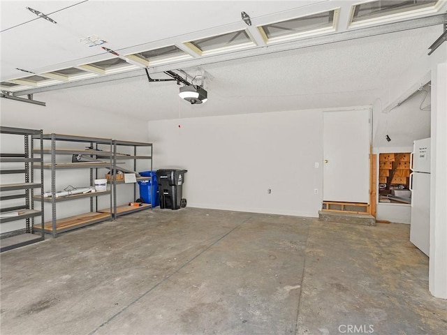 9531 Via Ricardo, Sun Valley, CA 91504 - garage featuring a garage door opener and freestanding refrigerator