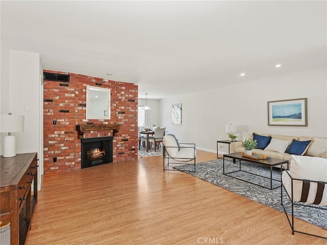 9531 Via Ricardo, Sun Valley, CA 91504 - living area featuring light wood-style flooring, recessed lighting, and a brick fireplace