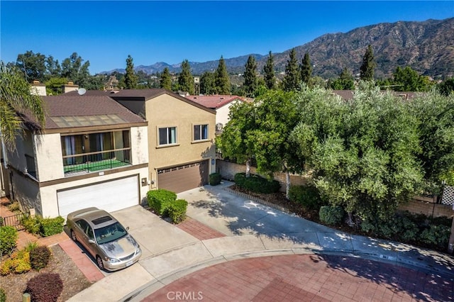 887 San Juan Cir, Duarte, CA 91010 - view of front facade with concrete driveway, stucco siding, an attached garage, and a mountain view