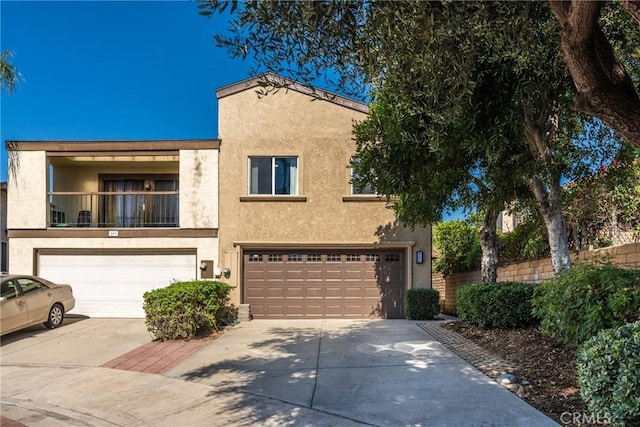 887 San Juan Cir, Duarte, CA 91010 - mediterranean / spanish-style house featuring stucco siding, concrete driveway, a garage, and a balcony