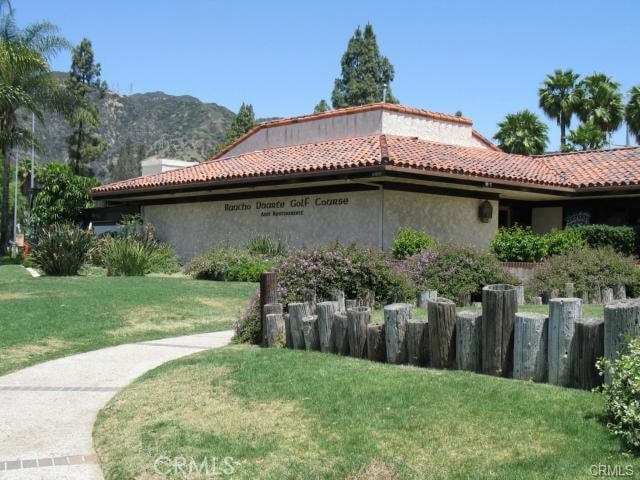 887 San Juan Cir, Duarte, CA 91010 - view of property exterior featuring a lawn, a tile roof, and a mountain view