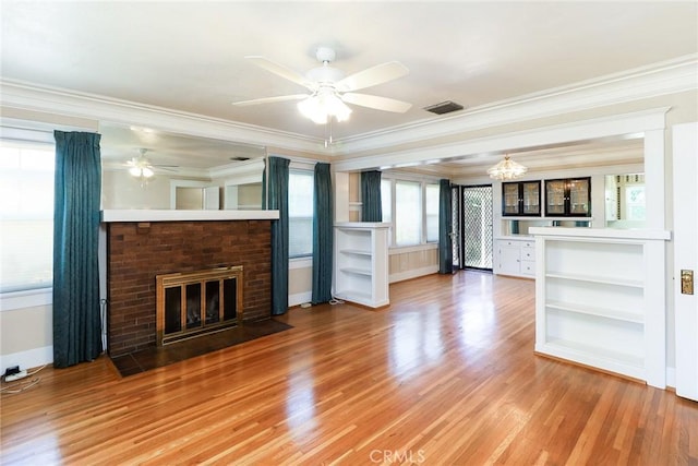 845 N Curtis Ave, Alhambra, CA 91801 - unfurnished living room with ornamental molding, ceiling fan, light wood-style floors, a brick fireplace, and a chandelier