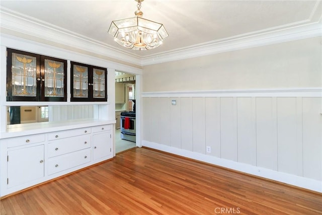 845 N Curtis Ave, Alhambra, CA 91801 - unfurnished room with a chandelier, light wood-type flooring, ornamental molding, and a wainscoted wall