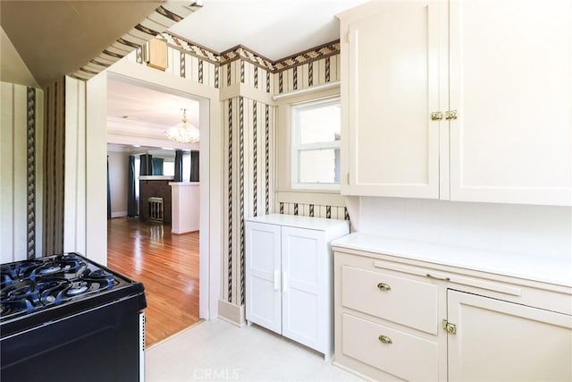 845 N Curtis Ave, Alhambra, CA 91801 - kitchen with gas stove, a chandelier, light countertops, and white cabinetry