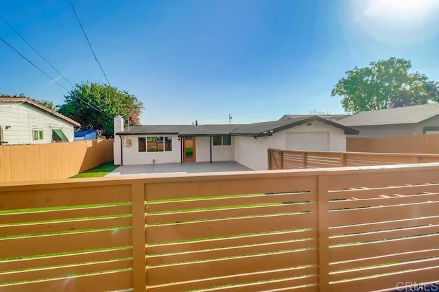 9753 Ivanho St, Spring Valley, CA 91977 - view of front facade featuring a garage and stucco siding