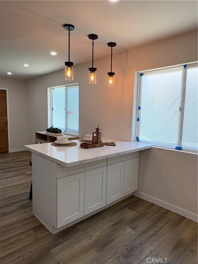 1526 W 54th St, Los Angeles, CA 90062 - kitchen with dark wood-style floors, pendant lighting, a peninsula, recessed lighting, and light stone countertops