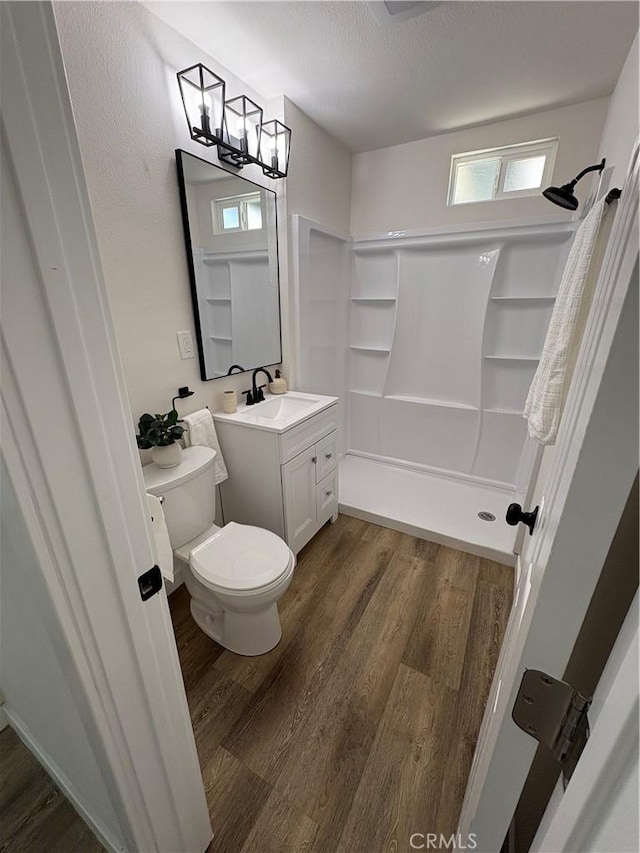 1526 W 54th St, Los Angeles, CA 90062 - full bath featuring wood finished floors, a shower, vanity, a textured ceiling, and a chandelier