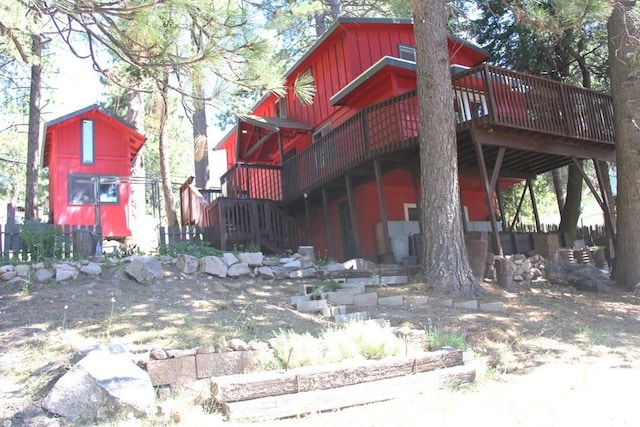 31705 Silver Spruce Dr, Running Springs, CA 92382 - rear view of house featuring board and batten siding and a wooden deck