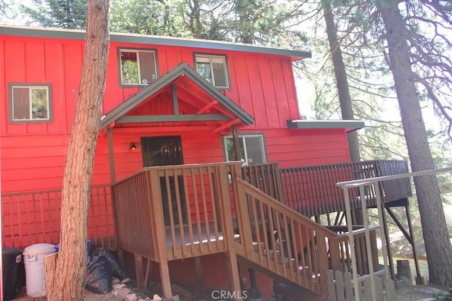 31705 Silver Spruce Dr, Running Springs, CA 92382 - view of front of home featuring stairway, a deck, and board and batten siding