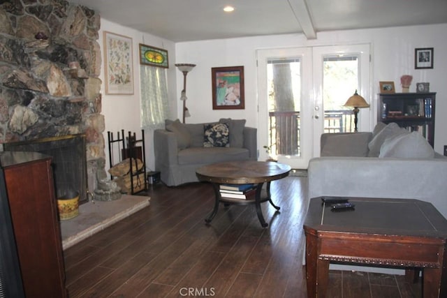 31705 Silver Spruce Dr, Running Springs, CA 92382 - living area featuring wood finished floors, beamed ceiling, french doors, and a fireplace