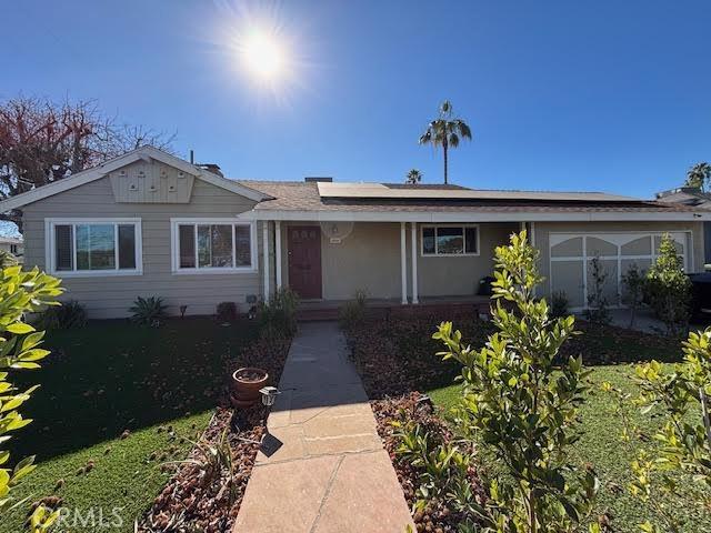 13600 Sylvan St, Valley Glen, CA 91401 - view of front of house featuring roof mounted solar panels and a porch