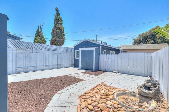 4711 Landis St, San Diego, CA 92105 - fenced backyard featuring a patio area and a storage shed
