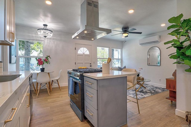 4711 Landis St, San Diego, CA 92105 - kitchen featuring island range hood, stainless steel range with gas cooktop, a breakfast bar, recessed lighting, and gray cabinetry