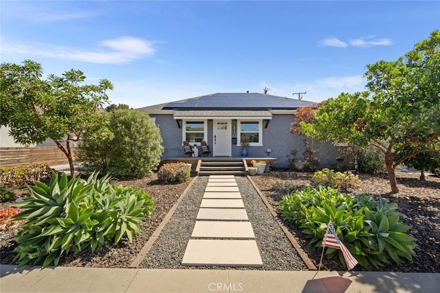 4513 E Cervato St, Long Beach, CA 90815 - view of front of property featuring stucco siding, roof mounted solar panels, and a porch