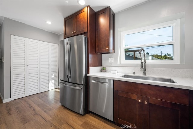 4513 E Cervato St, Long Beach, CA 90815 - kitchen with stainless steel appliances, dark wood finished floors, light countertops, recessed lighting, and dark brown cabinets