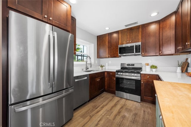 4513 E Cervato St, Long Beach, CA 90815 - kitchen featuring appliances with stainless steel finishes, light wood-type flooring, recessed lighting, and wooden counters