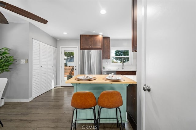 4513 E Cervato St, Long Beach, CA 90815 - kitchen featuring freestanding refrigerator, a breakfast bar area, dark wood-style floors, recessed lighting, and wood counters