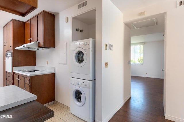 777 E Valley Blvd Unit 142, Alhambra, CA 91801 - laundry area featuring stacked washer and clothes dryer, attic access, and light wood-style flooring