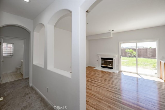 13056 Hagar St, Sylmar, CA 91342 - corridor featuring arched walkways and wood finished floors