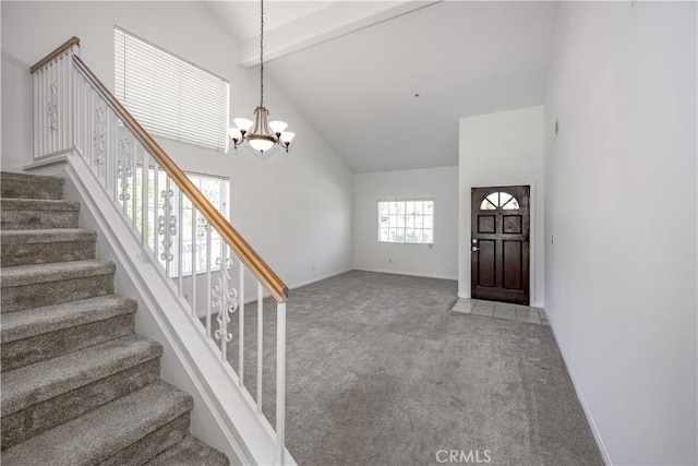13056 Hagar St, Sylmar, CA 91342 - carpeted foyer entrance featuring high vaulted ceiling, a chandelier, stairway, and beam ceiling