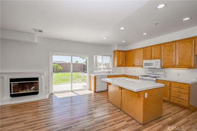 13056 Hagar St, Sylmar, CA 91342 - kitchen featuring white appliances, tile counters, a center island, recessed lighting, and light wood-style floors