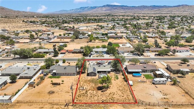 13144 Algonquin Rd, Apple Valley, CA 92308 - aerial perspective of suburban area featuring a mountainous background and property parcel outlined