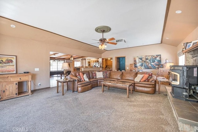 60810 Sunrise Rd, Whitewater, CA 92282 - carpeted living area featuring vaulted ceiling, a wood stove, and ceiling fan
