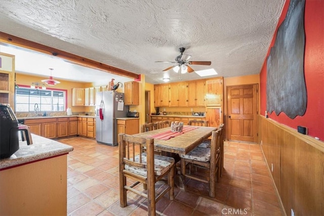 60810 Sunrise Rd, Whitewater, CA 92282 - dining space featuring a ceiling fan, wainscoting, and a textured ceiling