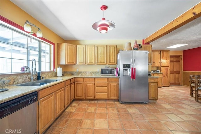 60810 Sunrise Rd, Whitewater, CA 92282 - kitchen featuring appliances with stainless steel finishes, light countertops, hanging light fixtures, and beam ceiling