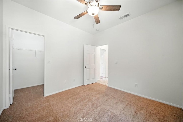 12038 Diego Ct, Moreno Valley, CA 92557 - unfurnished bedroom with light colored carpet, a walk in closet, and ceiling fan