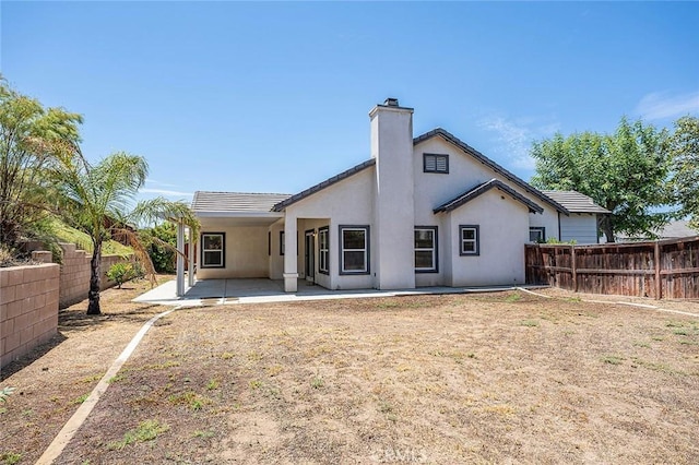 12038 Diego Ct, Moreno Valley, CA 92557 - rear view of property with a patio area, a fenced backyard, a chimney, and stucco siding