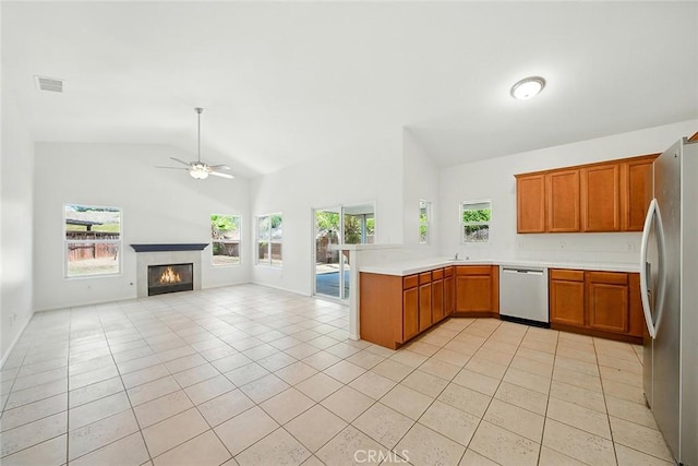 12038 Diego Ct, Moreno Valley, CA 92557 - kitchen with appliances with stainless steel finishes, a peninsula, open floor plan, ceiling fan, and light tile patterned flooring