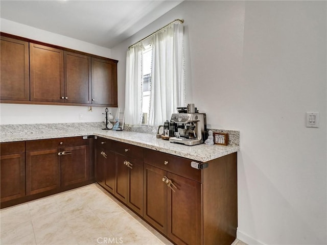 11576 S Crescent St, Desert Hot Springs, CA 92240 - kitchen featuring light stone countertops and dark brown cabinetry