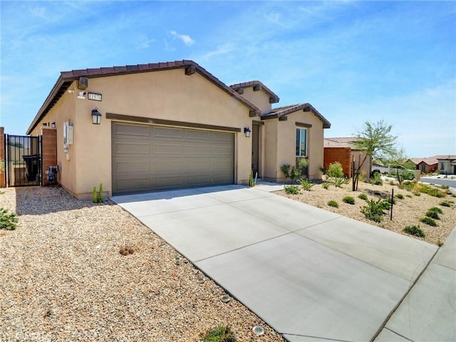 11576 S Crescent St, Desert Hot Springs, CA 92240 - view of front of property featuring stucco siding, a garage, driveway, and a gate