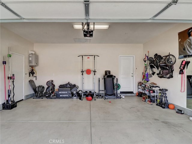 11576 S Crescent St, Desert Hot Springs, CA 92240 - garage featuring a garage door opener and tankless water heater