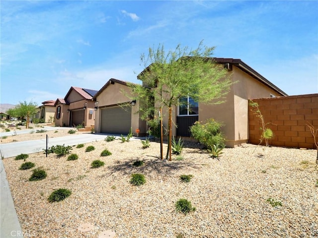 11576 S Crescent St, Desert Hot Springs, CA 92240 - single story home with stucco siding, an attached garage, and driveway