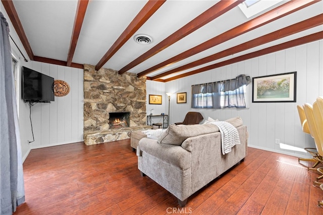 9802 Swallow Ln, Garden Grove, CA 92841 - living room with dark wood-type flooring, beamed ceiling, and a fireplace